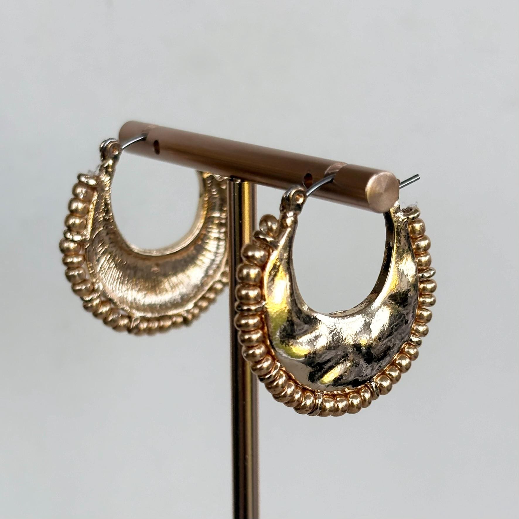Hammered Gold Crescent Hoop Earrings with decorative fringed edge